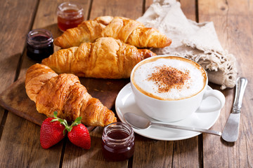 Breakfast with cup of cappuccino coffee with croissants