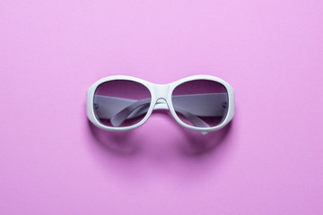 Studio shot of white sunglasses on pink background, Summer is coming concept