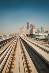 Fototapeta na wymiar Railway and city buildings view in Dubai