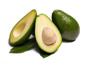 Fresh organic ripe green whole and sliced Fuerte avocado with leaves, copy space close up isolated on white background