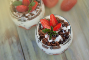 Strawberry Cake in Glass with White Crea mans Strawberry. Homemade summer dessert on white rustic table.