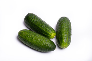 Fresh small green cucumbers close up copy space isolated on white background