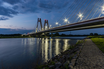 modern bridge over Vistula river, Krakow, Poland, illuminated in the night