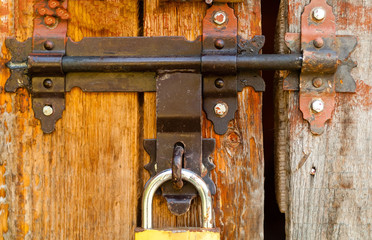 vintage lock on a rusty loop on a wooden background, copy space, closeup,concept of authentic objects