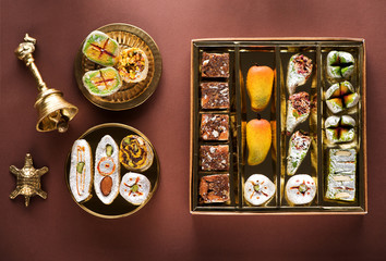 Indian sweets and Mithai in a box and a plate. Diwali festival concept, flat lay, top view
