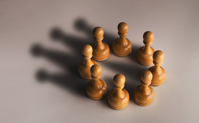 Chess pawn circle with shadow shaped as crown
