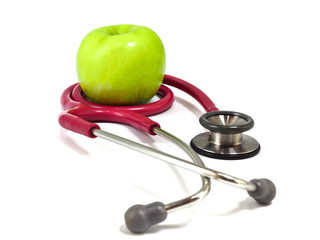 Stethoscope and fresh green apple on white background. Healthy food and lifestyle concept.