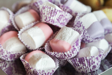 Fototapeta na wymiar Pink and violet marshmallows at restaurant candy bar