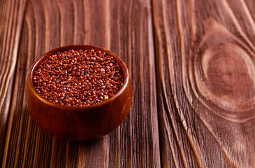 Red quinoa wheat in wooden bowl