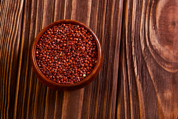 Red quinoa wheat in wooden bowl