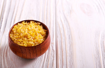 Bulgur wheat in wooden bowl