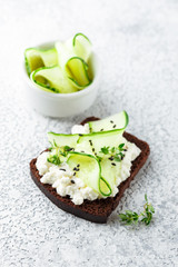 Toasts with ricotta, cucumber and black sesame