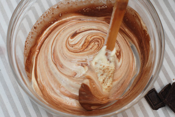 Mixing with Wooden Spoon Butter Dough in Glass Bowl. Cooking Chocolate Pie. Top view.