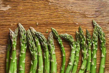 green asparagus on wet kitchen table top view space for text