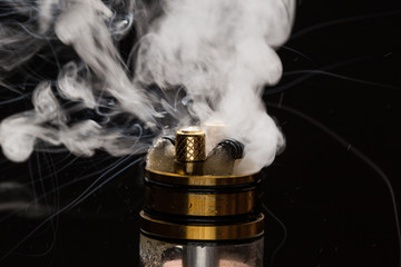 Vape close-up with smoke on a black background