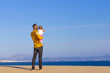 Dad and baby daughter in the beach