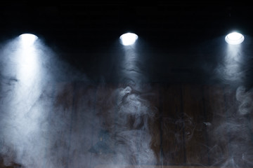 Fototapeta na wymiar Lamps of light with a cloud of smoke. Close-up.