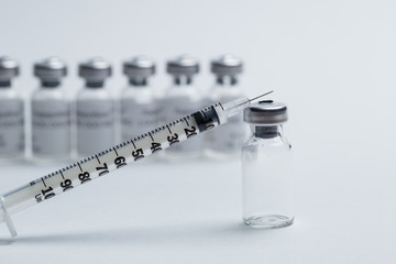 vial and syringe for vaccine on white background closeup