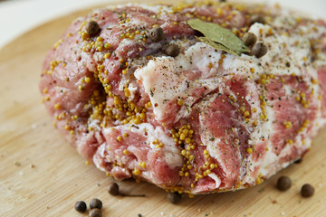 A large piece of fatty pork meat marinated with mustard, pepper and various spices