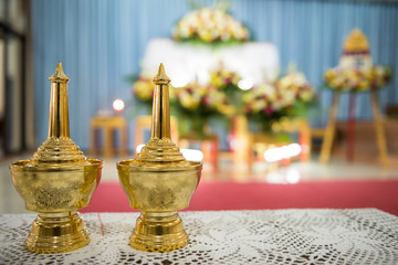 Small golden brass vase pots to pour water fo Asian Buddhist cremation or funeral ceremony