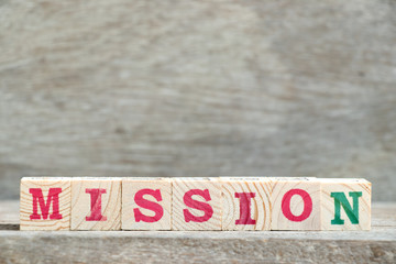Letter block in word mission on wood background