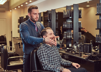 Professional barber working with client in a hairdressing salon.