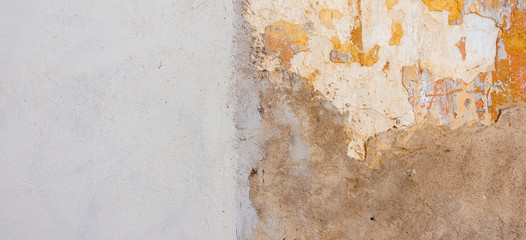 Beige new plastered wall with damaged old painted wall as banner background