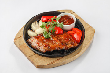 Fried meat with vegetables on pan