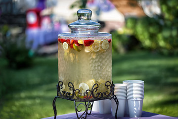 Homemade lemonade with fresh fruits on party table