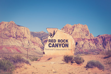 Rock boulder sign for Red Rock Canyon in Las Vegas Nevada with mountains in the background