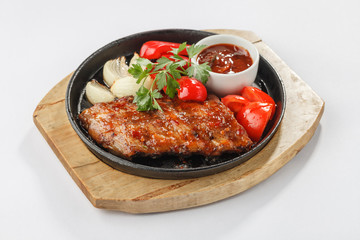 Fried meat with vegetables on pan