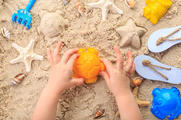 top view of child playing in sand summer toys