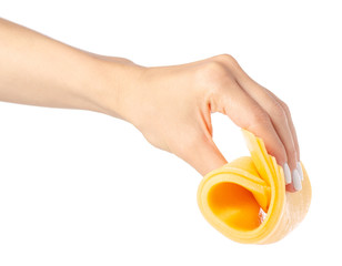 A slice of cheese in a hand on a white background isolation