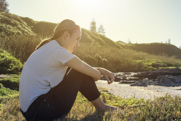 Young woman sitting and relaxing in morning sun