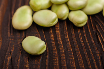 fresh broad beans on a rustic background
