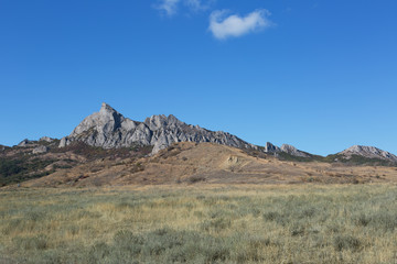 Fototapeta na wymiar Rocks of the extinct volcano KaraDag in autumn day