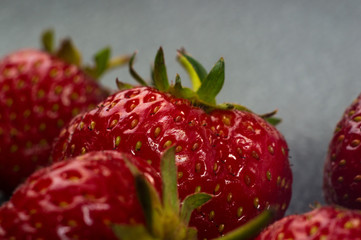 fresh ripe strawberries on black ceramic plate