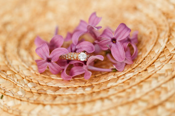 jewelry engagement ring with diamonds and spring lilac flowers