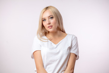 Obraz premium serious woman in blond wig on the white background