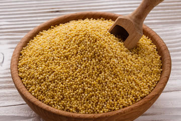 bowl of millet on a white wooden background