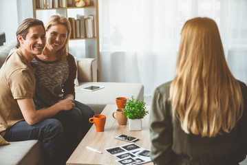 I want to help you. Portrait of happy married couple speaking with surrogate expectant mother in...