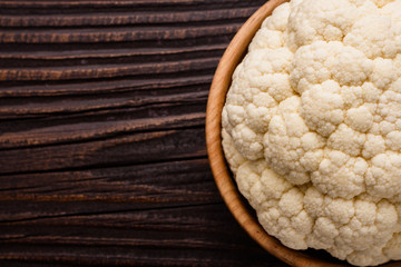 fresh cauliflower on a rustic wooden background