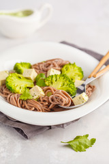 Vegetarian Soba Noodles with tofu and broccoli, white background. Healthy vegan food concept.