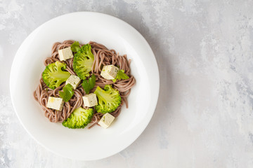 Vegetarian Soba Noodles with tofu and broccoli, top view. Healthy vegan food concept.