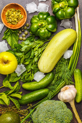 Green vegetables on a dark background. Vegetable vegan diet food background, top view. Healthy lifestyle concept.