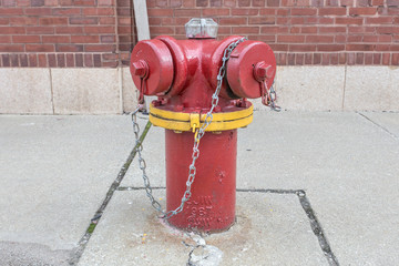 Fototapeta na wymiar Red fire hydrant on old sidewalk