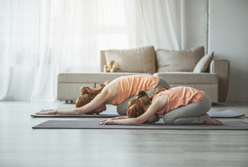 Mother and daughter exercising at home