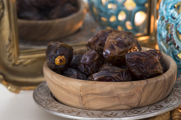 Date fruits and mirror on the white background with blue candle for Muslims Ramadan and three months concept.