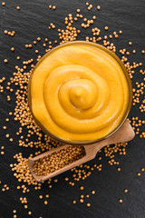 mustard in a bowl on a rustic background