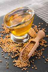 fresh mustard oil on a rustic background